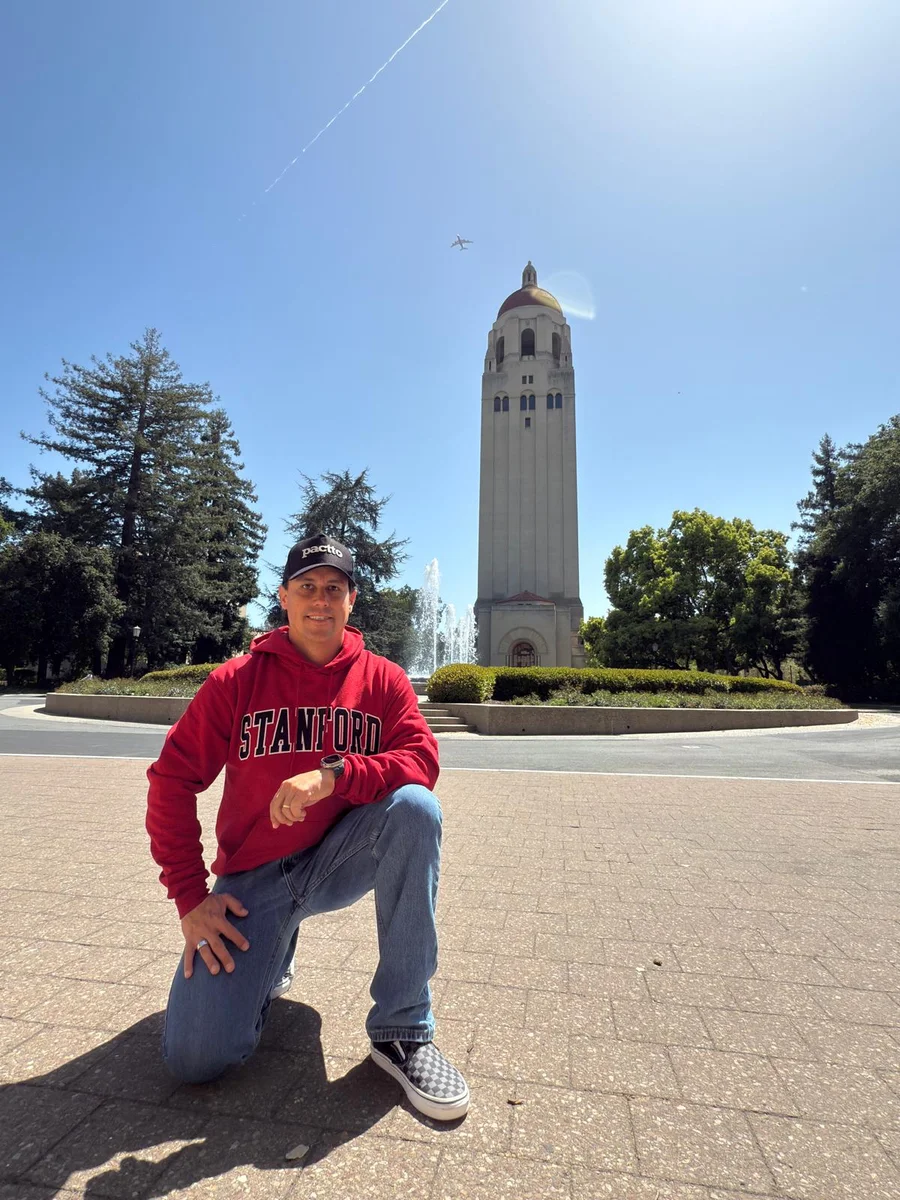 Demian wearing a Stanford hoodie on campus